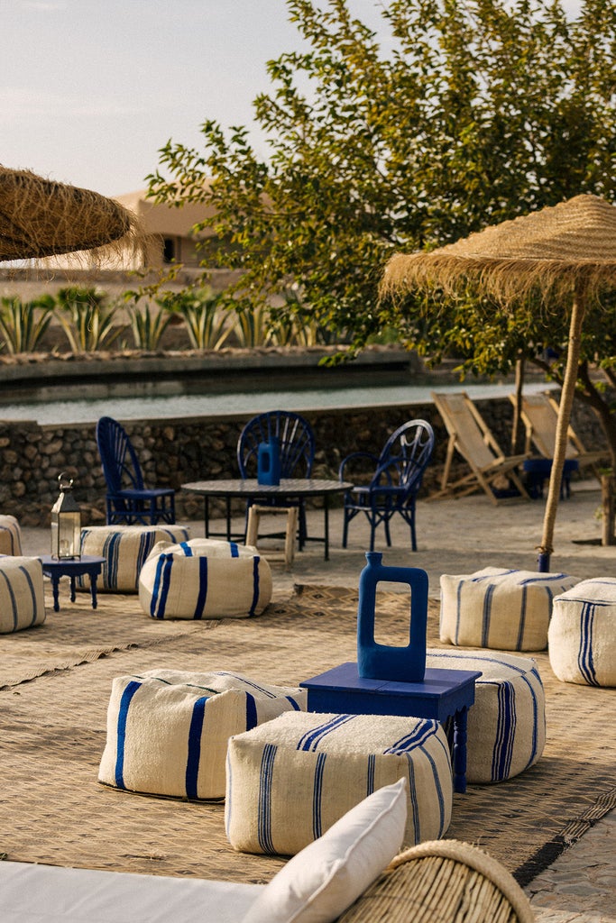 Luxurious desert camp tent with white canvas dome, private terrace, and panoramic mountain views across Morocco's Agafay desert landscape