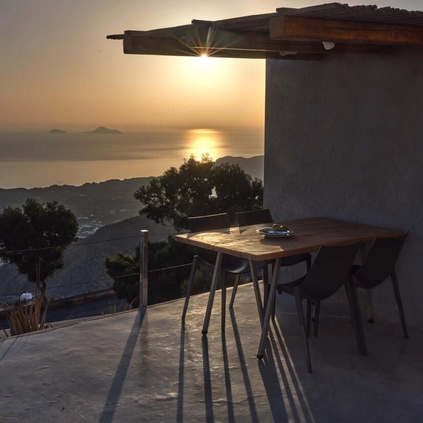 Luxurious white-washed Santorini villa overlooking azure Aegean Sea, featuring minimalist design, infinity pool, and dramatic cliff-edge panoramic view