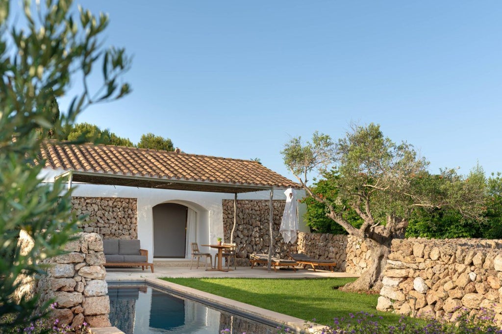 Luxurious stone cottage with whitewashed walls, rustic wooden accents, and minimalist design nestled in scenic Spanish countryside landscape