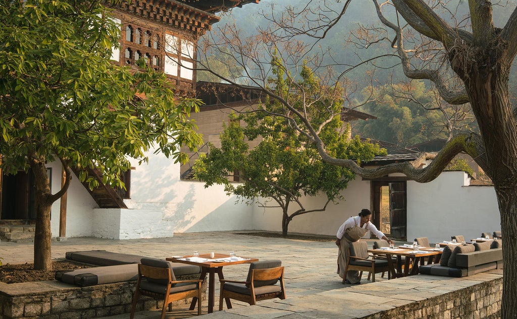 Luxurious mountain lodge with infinity pool overlooking Bhutanese valley, traditional architecture blends with modern design elements