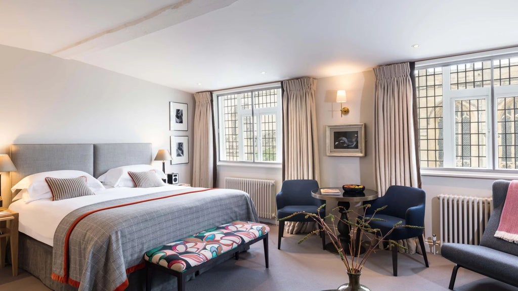 Elegant classic hotel room with rich mahogany furnishings, crisp white linens, and period architectural details in historic Old Bank Hotel, United Kingdom