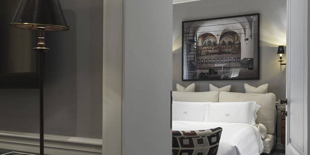 Elegant family suite at J.K. Place Roma with designer furnishings, plush bedding, and warm neutral tones reflecting sophisticated Italian hospitality