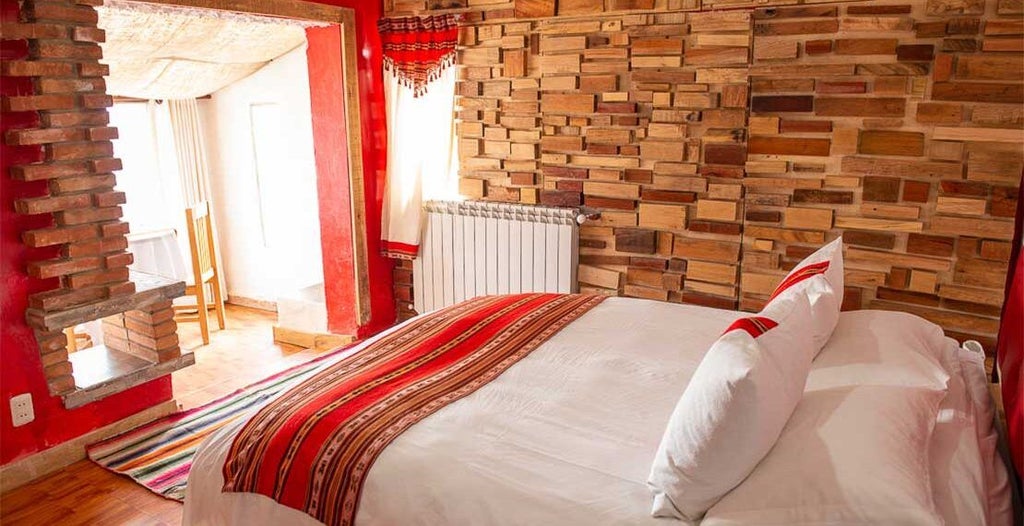 Luxurious double superior room at Flamencos Altiplano Eco-Hotel, featuring elegant decor, plush bedding, and panoramic mountain landscape in Bolivia