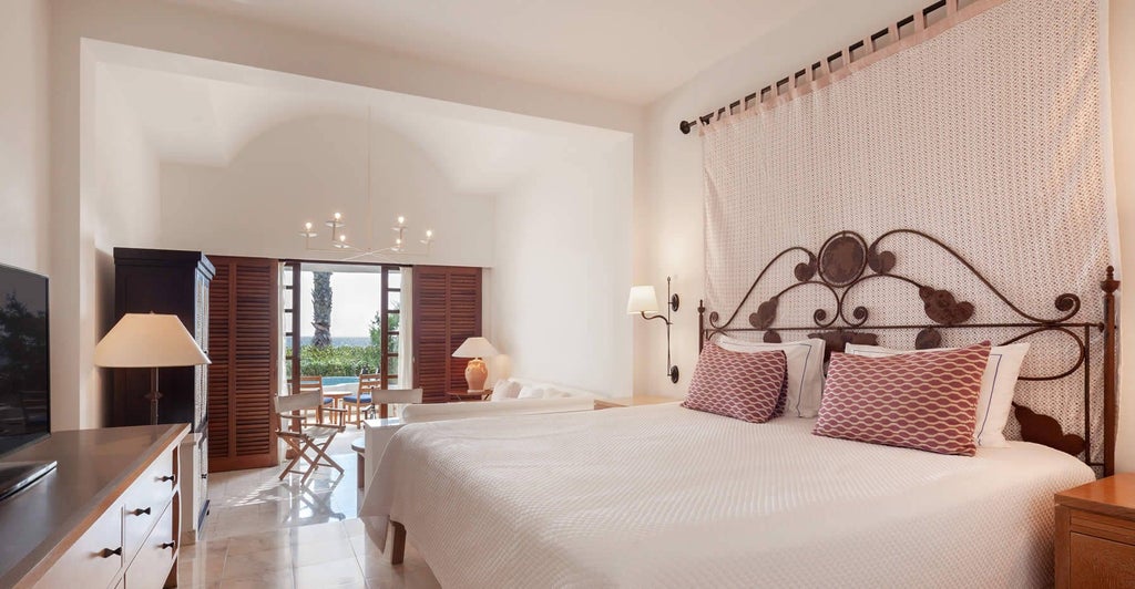 Elegant Artemis Suite with panoramic sea view, featuring plush king bed, modern marble bathroom, and private balcony overlooking Mediterranean coastline in Cyprus