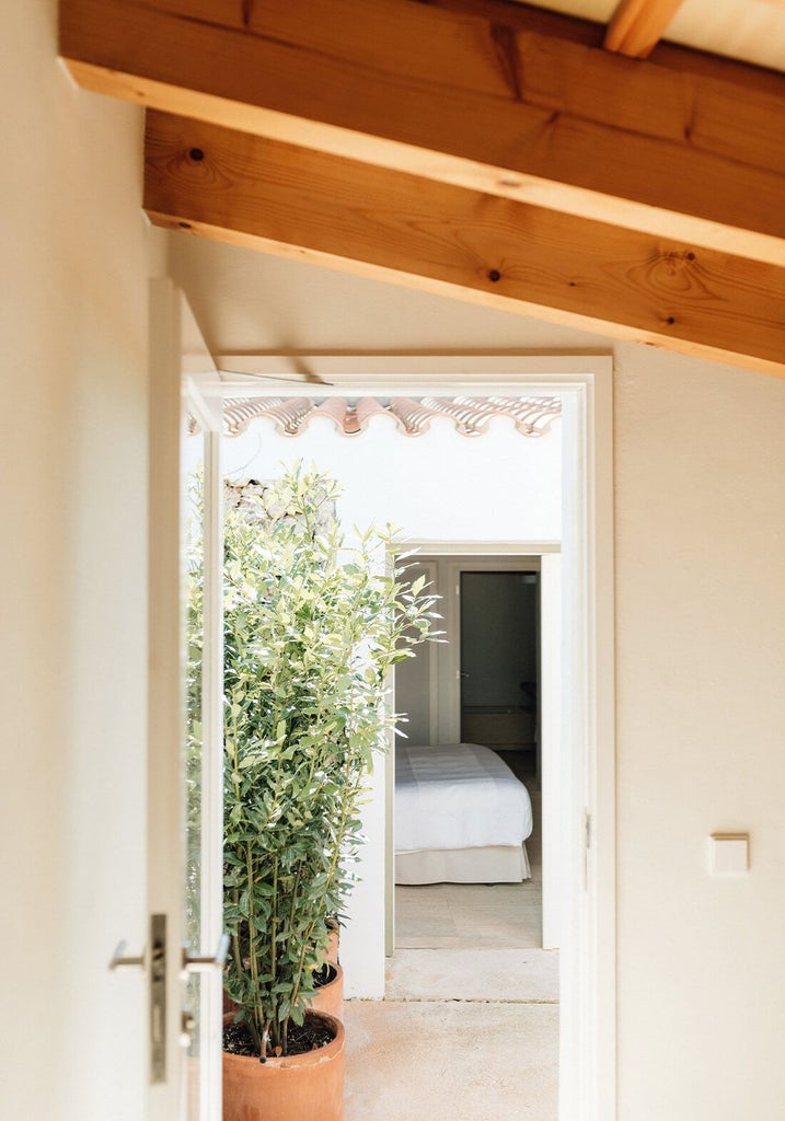 Whitewashed stone cottage with private garden, rustic Mediterranean terracotta tiles, and minimalist Menorcan design at Torralbenc luxury retreat