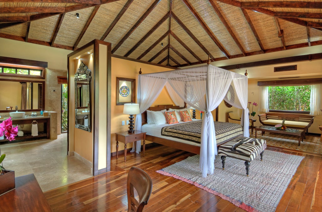 Elegant private plunge pool surrounded by lush rainforest, overlooking modern villa with glass walls and tropical wood accents at luxury resort