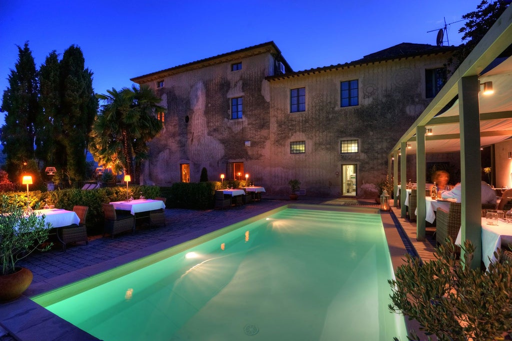 Elegant Tuscan villa with stone facade, terracotta roof, and lush cypress trees, overlooking rolling green hills of the Italian countryside at sunset