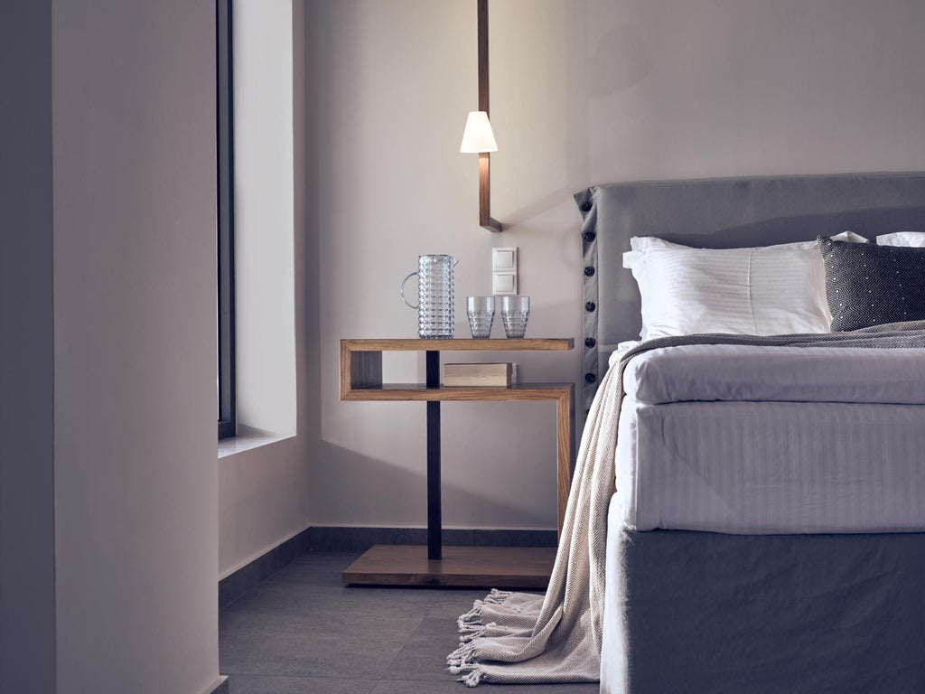 Luxurious white-washed Greek villa bedroom with panoramic sea view, minimalist design, crisp linens, and blue Aegean horizon through large windows