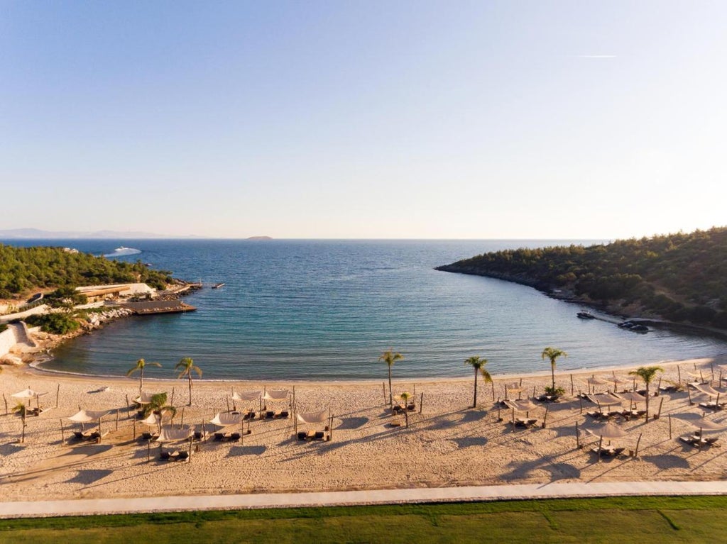 Sleek modern hotel complex nestled on Turkish coastline with infinity pools overlooking azure Mediterranean waters at sunset