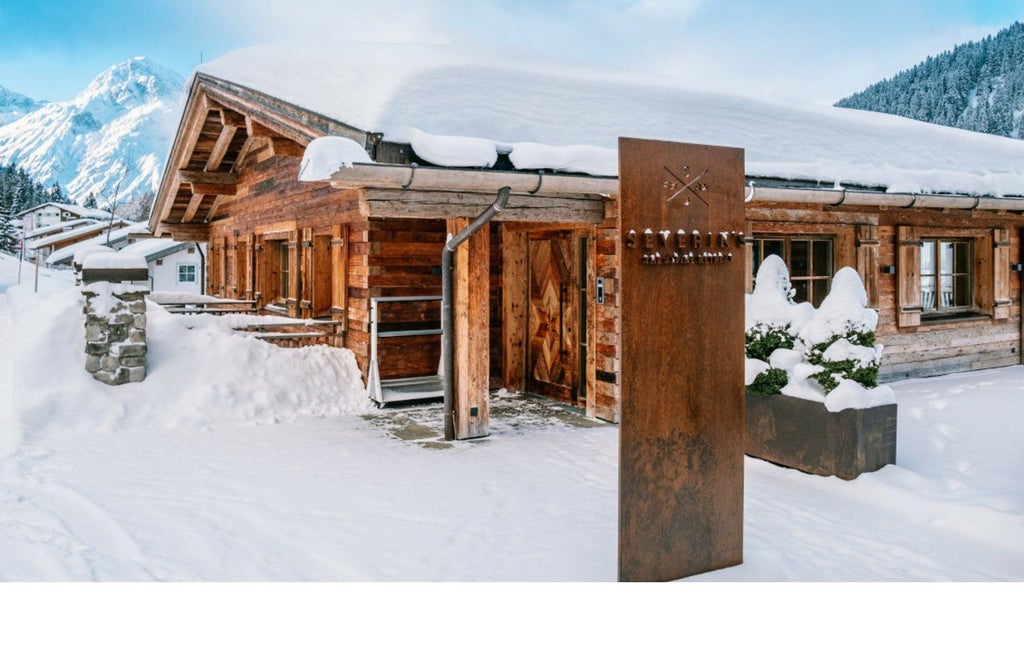 Luxurious Alpine chalet with panoramic mountain views, blending rustic wooden architecture and modern design against snow-capped Austrian mountain landscape