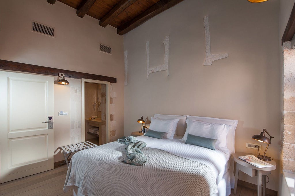 Elegant superior double room with crisp white linens, modern minimalist decor, and soft natural light in a luxurious Greek boutique hotel setting