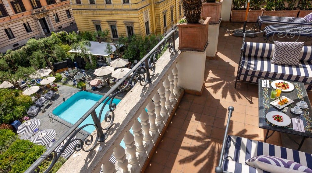 Elegant Dama Suite at Palazzo Dama, featuring plush white bedding, sleek marble-toned furnishings, and expansive windows overlooking Italian architectural charm