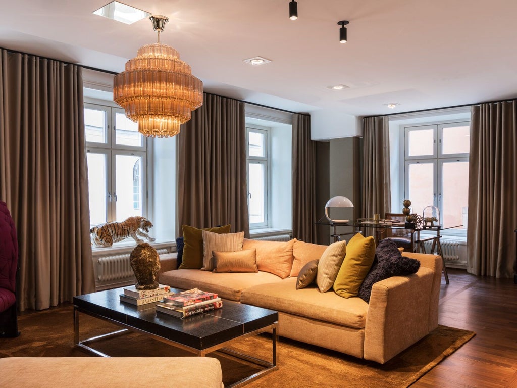 Elegant Stockholm hotel room with expansive street view, contemporary Nordic design, soft neutral tones, and floor-to-ceiling windows showcasing urban architectural landscape