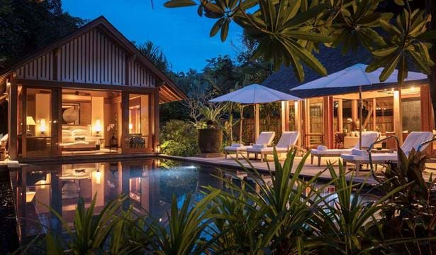 Luxurious rainforest resort villa with private infinity pool overlooking lush Malaysian jungle canopy and distant Andaman Sea views