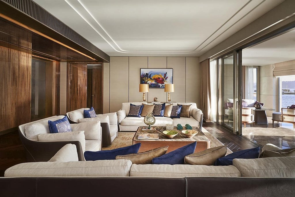 Luxurious Mandarin Bosphorus Suite overlooking Istanbul's waterfront, featuring elegant contemporary design with rich textures and panoramic Bosphorus strait views