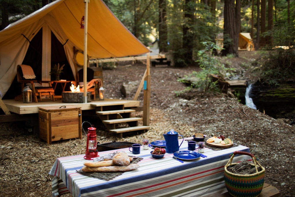 Canvas safari tent in redwood forest with private deck, luxury furnishings, and forest views at Ventana Big Sur glamping resort