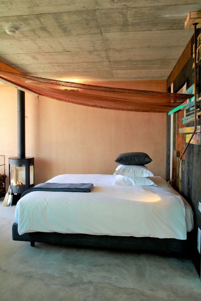 Luxurious wooden bungalow with ocean view at Noah Surf House, minimalist design featuring natural light, seaside backdrop, and contemporary coastal Portugal aesthetic