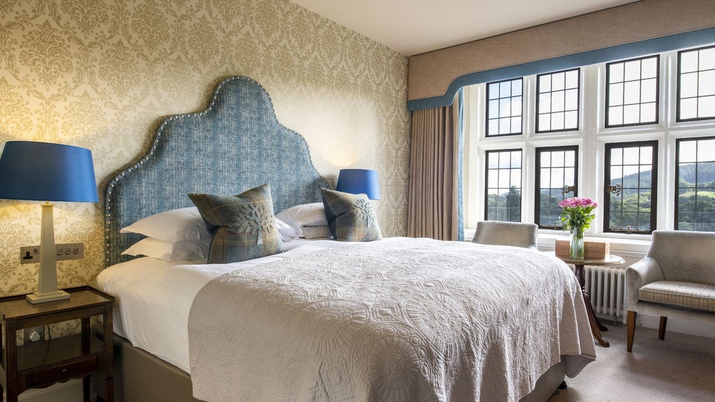 Luxurious valley room at Bovey Castle Hotel and Spa, featuring elegant decor, plush bedding, and panoramic countryside views in the United Kingdom