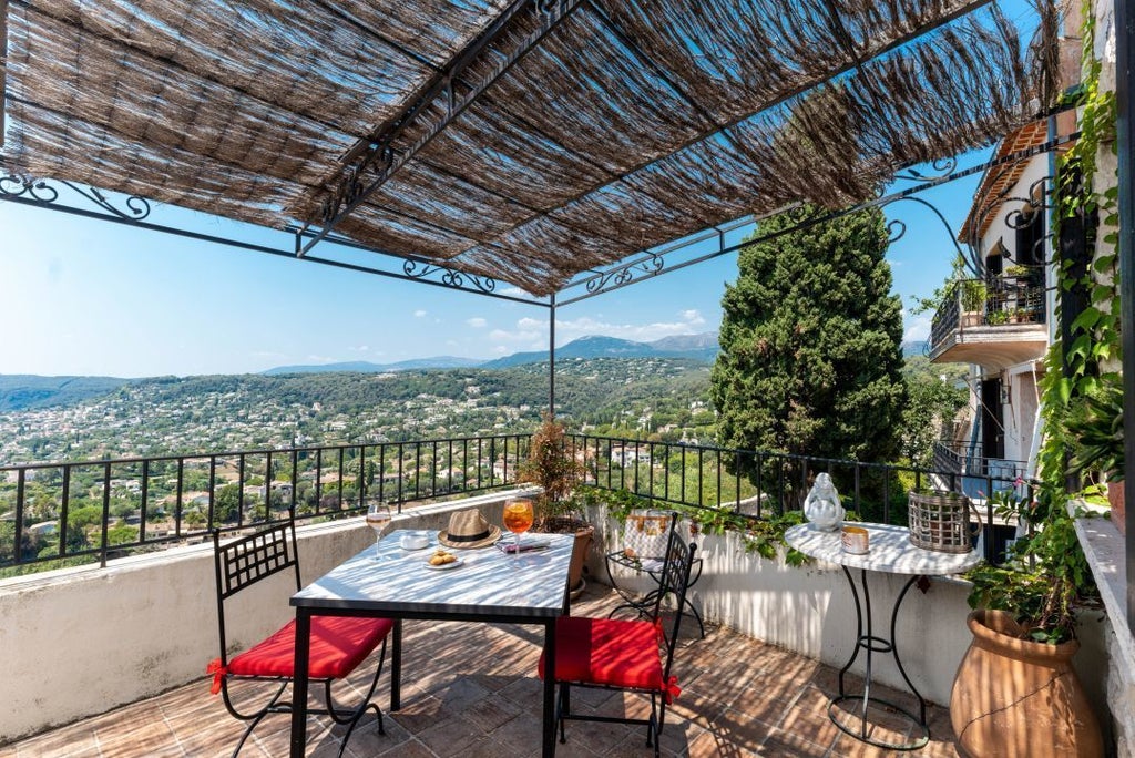 Luxurious panoramic suite at Hotel Le Saint with expansive terrace overlooking scenic French landscape, featuring elegant modern decor and sweeping natural views