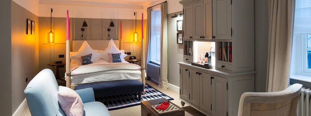 Spacious family hotel room with coastal charm, featuring plush white bedding, elegant furnishings, and a serene maritime-inspired color palette in Southwold, UK