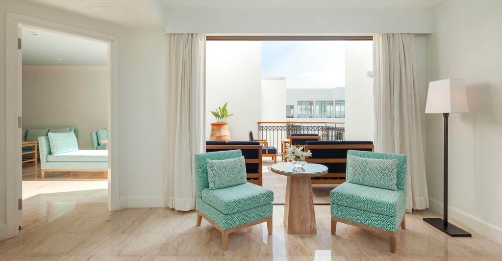 Luxurious Superior Sea View Suite at scenset Hotel, Cyprus, featuring elegant modern decor, spacious bedroom, panoramic azure Mediterranean views