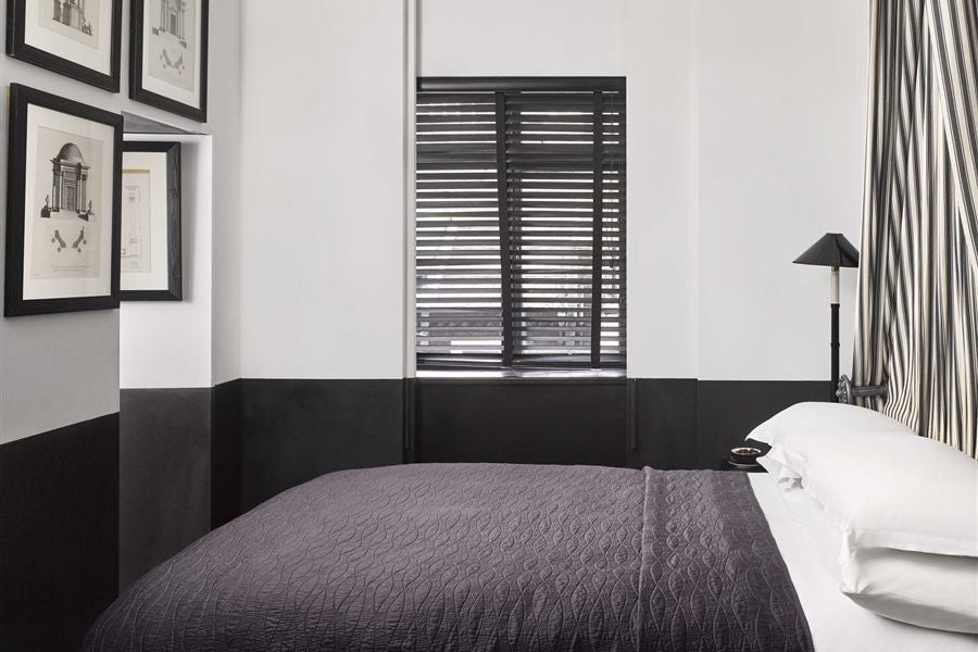 Elegant petit double room at scenset's Blakes Hotel, featuring rich burgundy textiles, ornate headboard, and sophisticated dark wood furnishings in United Kingdom