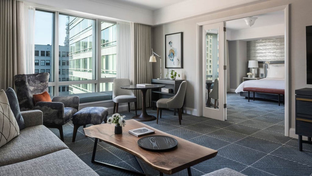 Elegant Four Seasons Executive Suite with panoramic city views, modern furnishings, plush king bed, and sleek marble bathroom in downtown San Francisco.