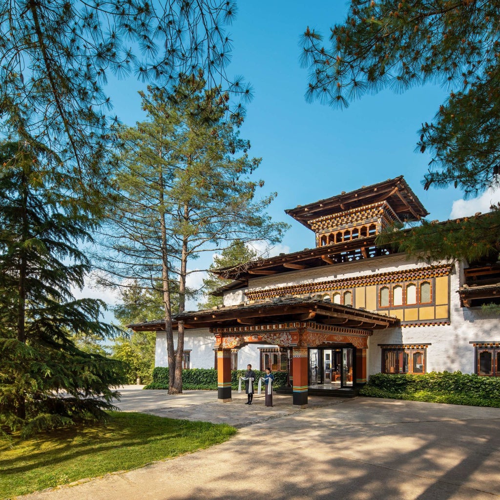 Luxurious COMO Uma Paro hotel nestled in Bhutan's mountainous landscape, with traditional Bhutanese architecture and sweeping Himalayan valley views