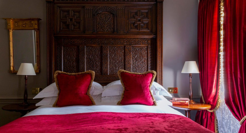 Opulent club double room with deep teal walls, plush velvet furnishings, antique four-poster bed, and ornate gold-framed artwork at Batty Langley's boutique hotel