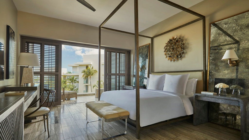 Luxurious rooftop suite balcony with private infinity pool overlooking Caribbean Sea, modern loungers and tropical landscaping at sunset