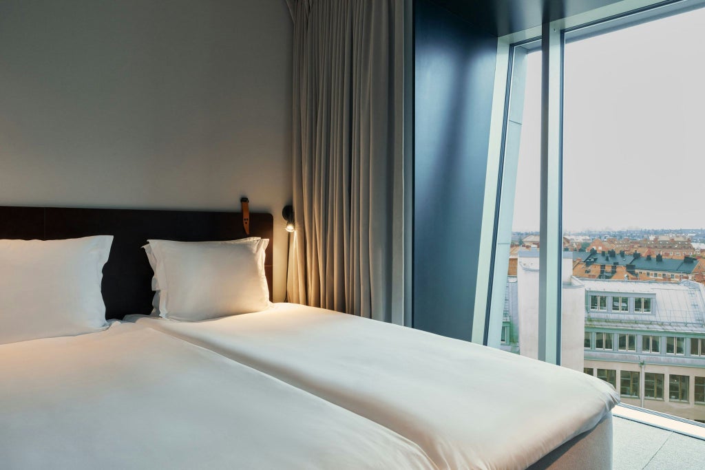 Modern minimalist hotel studio with sleek Nordic design, floor-to-ceiling windows, neutral color palette, and sophisticated urban scenery of Sweden's contemporary hospitality aesthetic