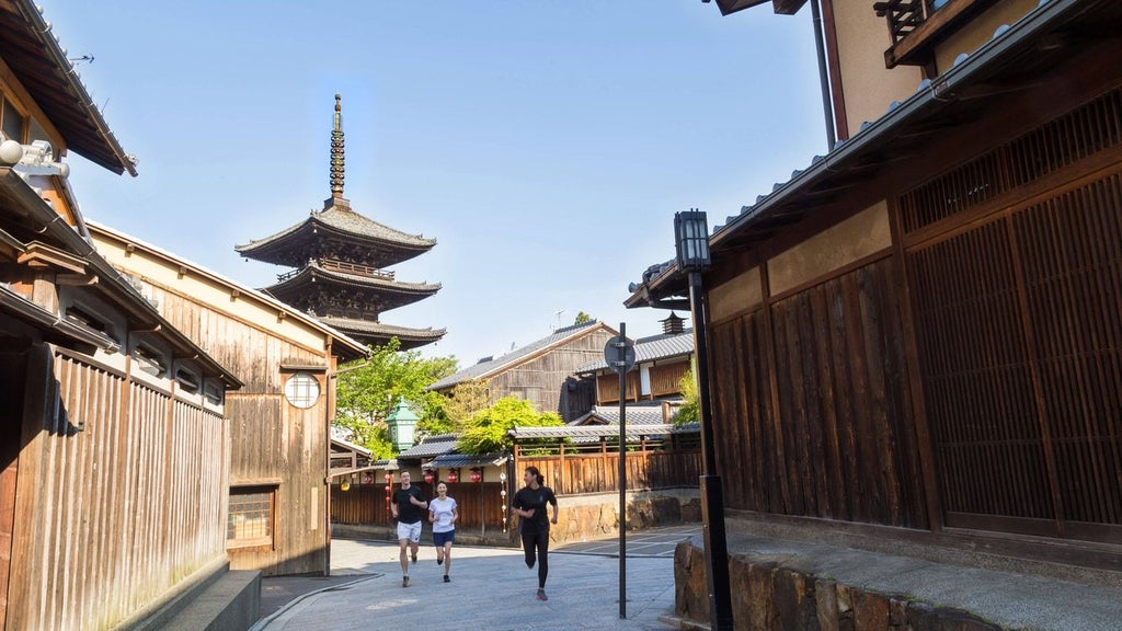 Luxurious riverside hotel with traditional Japanese architecture, wooden accents, and elegant facade overlooking the tranquil Kamo River in Kyoto