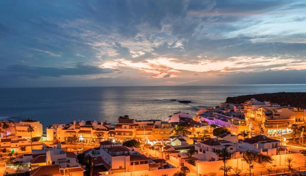 Modern luxury beachfront resort with white angular architecture, infinity pools, and ocean-view terraces set against Tenerife's coastline