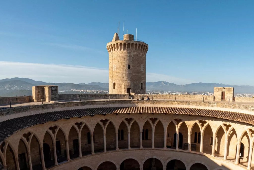 Elegant stone exterior of historic Convent de la Missió hotel, featuring warm limestone walls, arched windows, and Mediterranean architectural charm in Palma de Mallorca