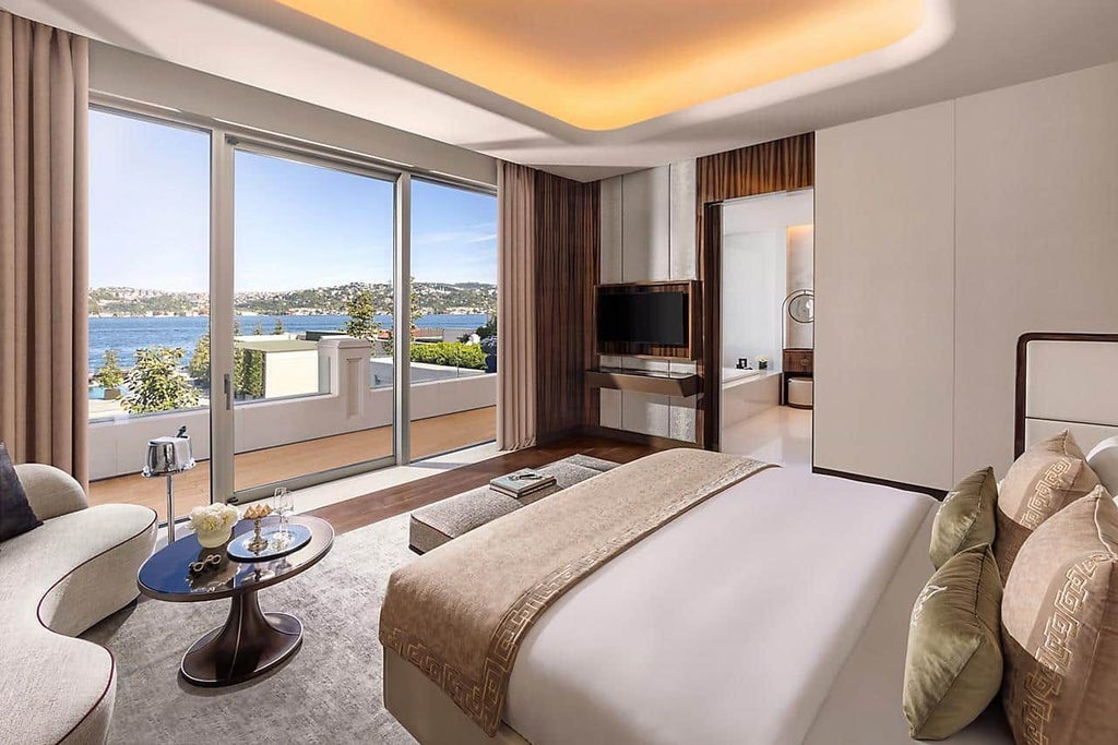 Luxurious one-bedroom suite at Mandarin Oriental Bosphorus with stunning waterfront view, elegant contemporary design, and plush king-sized bed overlooking Istanbul's skyline