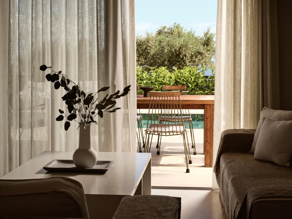 Elegant white-washed Greek villa bedroom with panoramic sea view, minimalist design, wooden floors, and luxurious king-size bed overlooking Aegean coastline