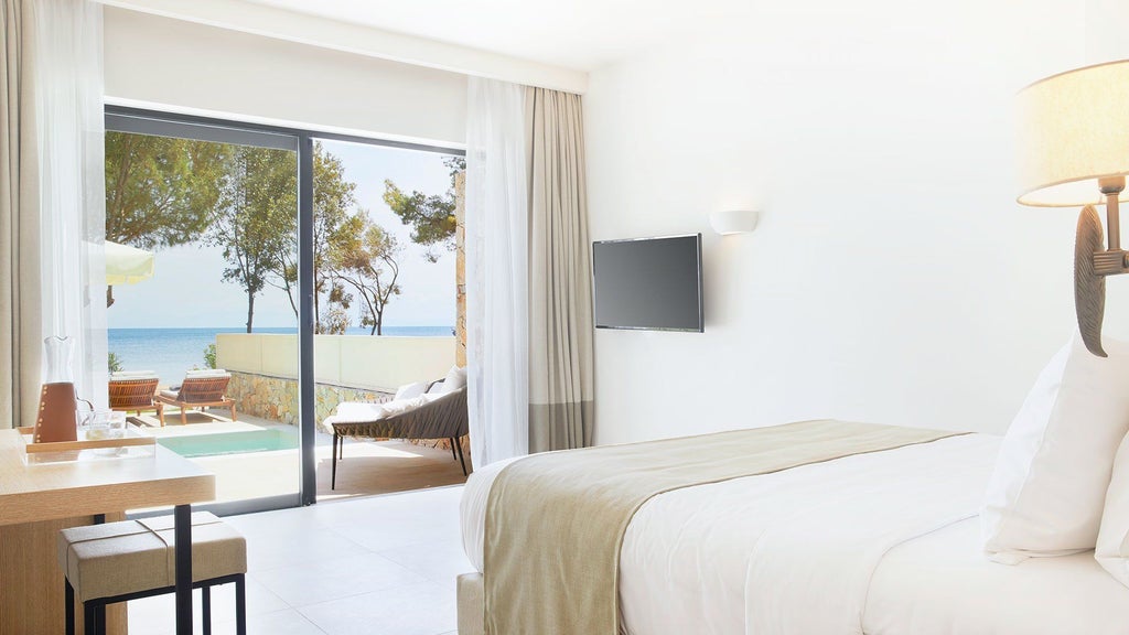 Luxurious white and blue GRACE Suite at ELIVI Skiathos hotel, featuring elegant minimalist design with sea view and modern coastal Greek decor