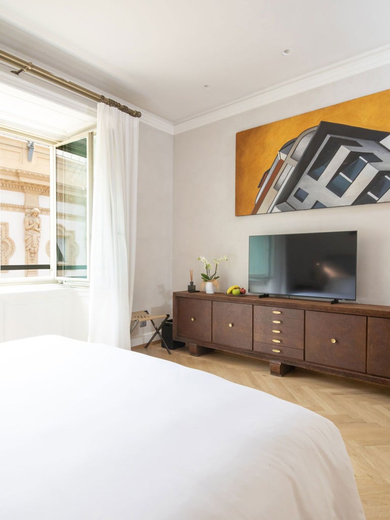 Luxurious deluxe gallery room at Scenset Vik Milano, featuring elegant contemporary design with expansive windows overlooking urban Italian landscape