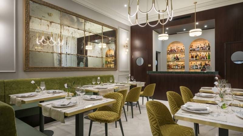 Elegant marble lobby of boutique hotel in Rome, featuring modern Italian design, crystal chandeliers, and luxurious neutral color palette with soft lighting