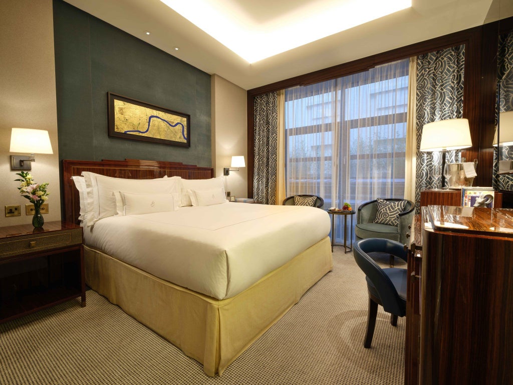 Luxurious classic hotel room at scenset Mayfair, featuring elegant neutral tones, plush bedding, and refined architectural details reflecting British sophistication.