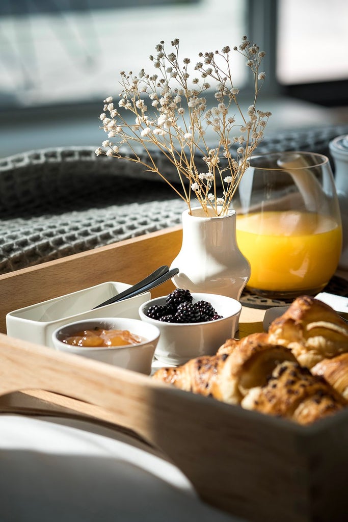 Luxurious hotel room at Casa de São Lourenço with panoramic mountain views, elegant modern decor, and large windows showcasing scenic Portuguese landscape