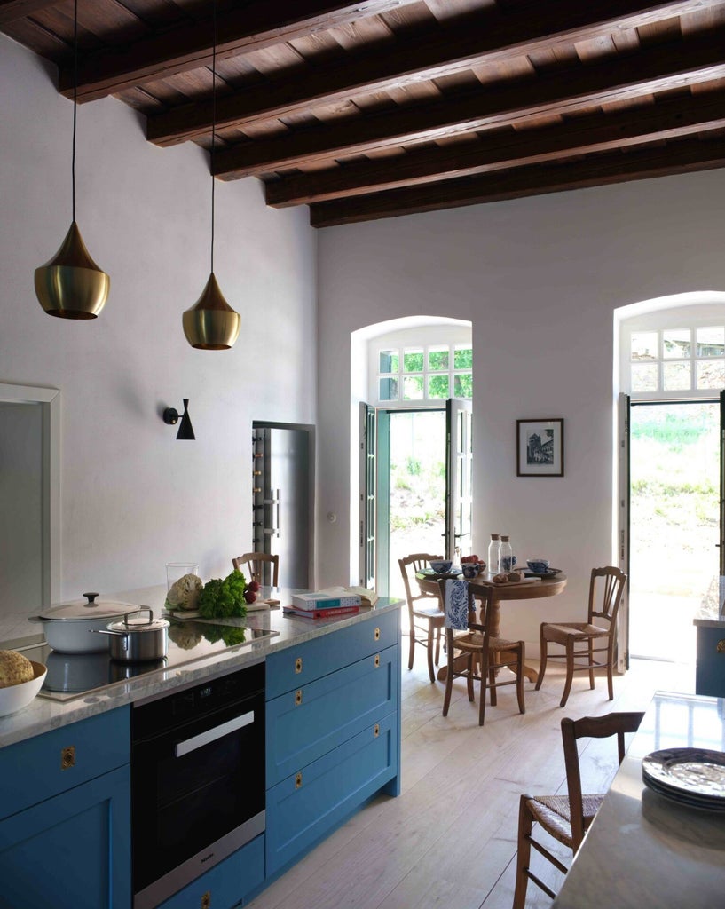 Rustic wooden interior of Caretaker's House at Bethlen Estates, featuring warm textiles, antique furniture, and soft natural light in Transylvanian countryside