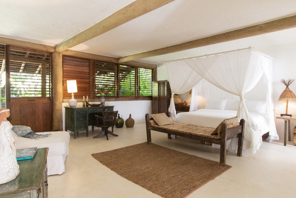 Rustic wooden interior of luxurious UXUA Casa Hotel studio in Trancoso, Brazil, with natural light, minimalist design, and traditional Brazilian craftsmanship