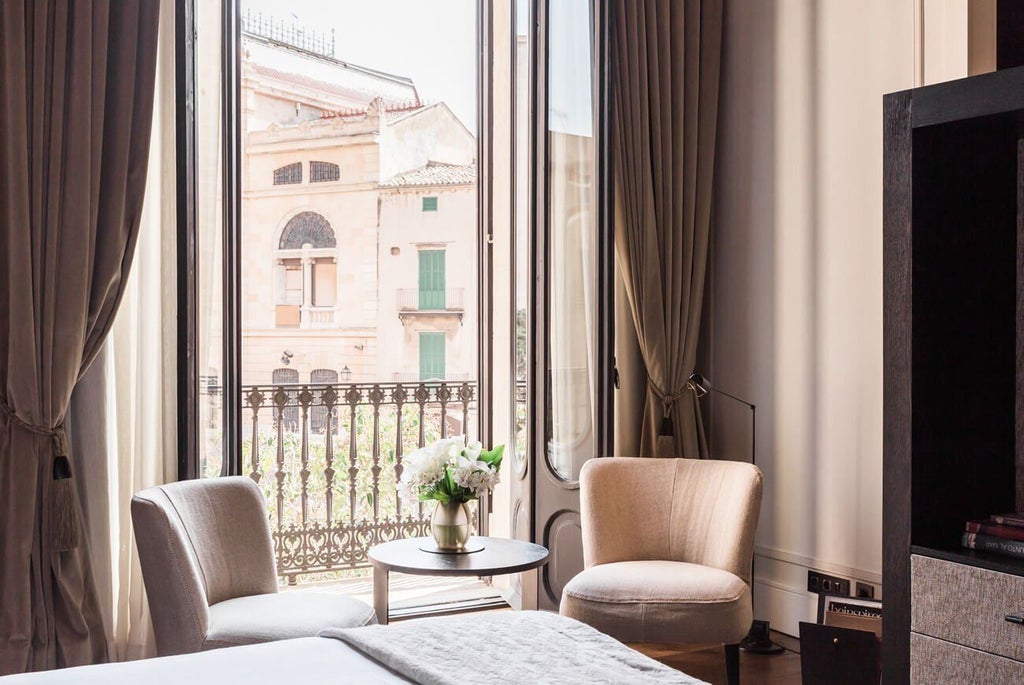 Luxurious junior suite at Sant Francesc Hotel Singular in Spain, featuring elegant design with warm wooden tones and sophisticated minimalist decor