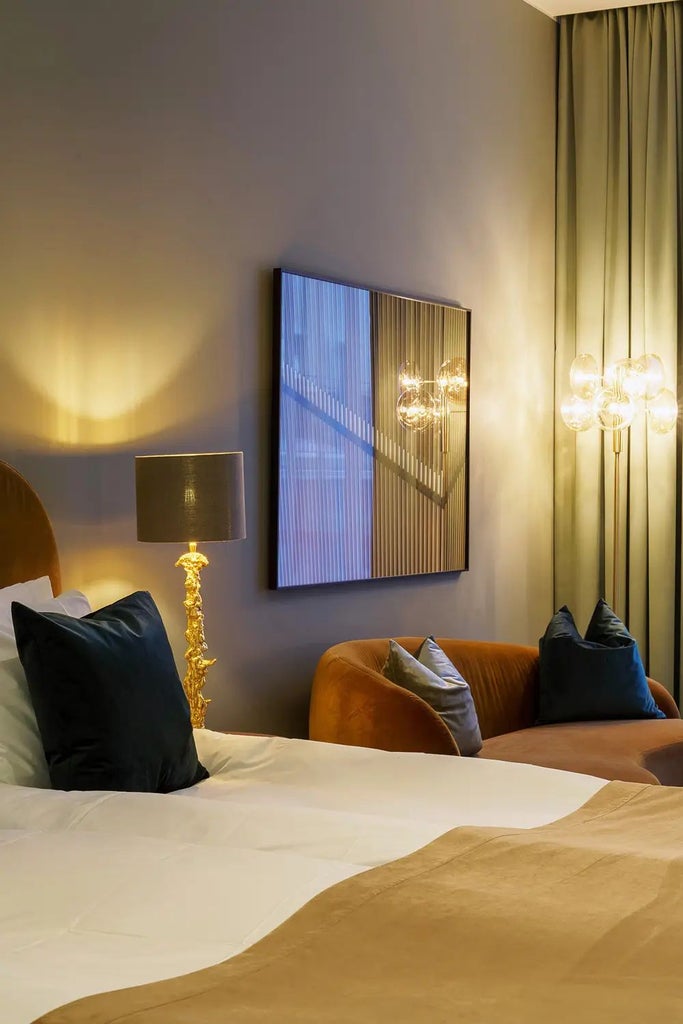 Elegant Swedish hotel room with sleek modern design, soft neutral tones, minimalist furniture, and large windows providing natural light and city views