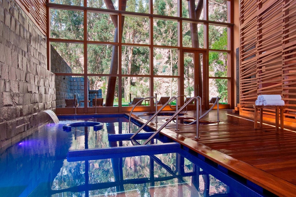 Luxurious mountain resort with stone and wood facade, reflecting in a still pond surrounded by manicured gardens and Andean peaks