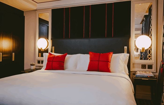 Elegant cabin room at The Scenset Townhouse, featuring plush velvet headboard, vintage-inspired decor, and warm ambient lighting in a refined UK setting