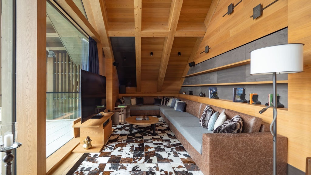 Luxurious alpine suite with modern Swiss design, featuring a spacious bedroom, floor-to-ceiling windows overlooking mountain landscape, and minimalist wooden furnishings