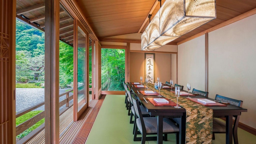 Luxurious traditional Japanese ryokan-style hotel with serene garden, elegant wooden architecture, and stone pathways at twilight in Kyoto