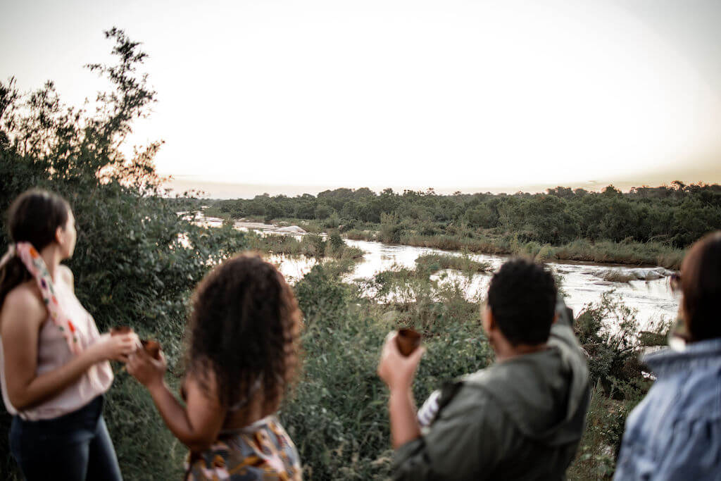 Luxurious train-hotel perched on Selati Bridge above Sabie River, featuring glass-walled suites with panoramic Kruger Park views